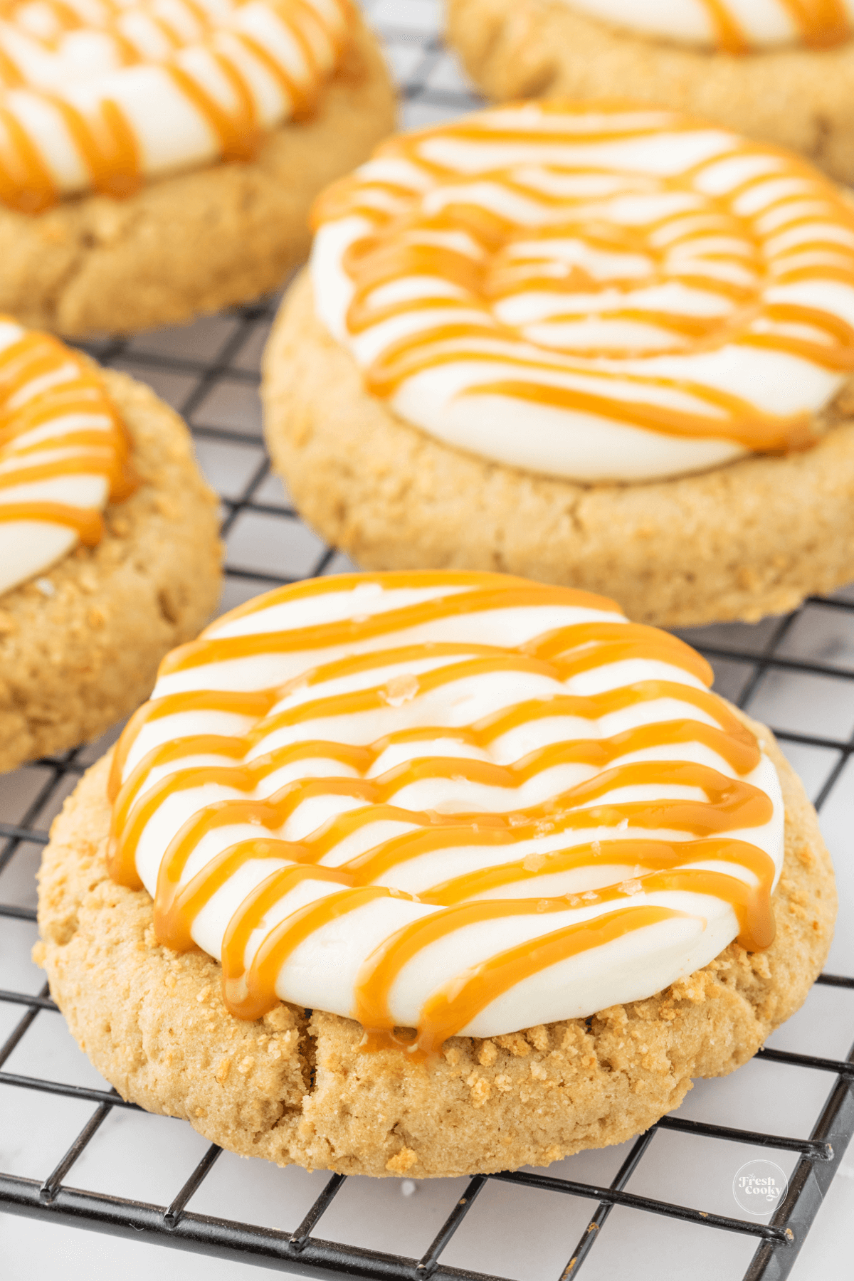 Salted caramel cheesecake cookies on cooling rack.