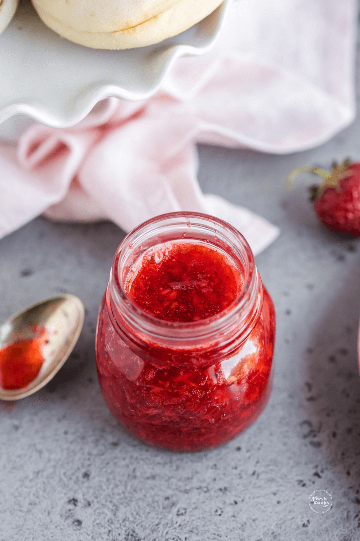 Strawberry freezer jam recipe in pretty jar.
