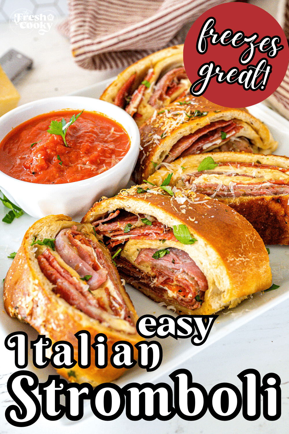 Italian Stromboli slices on a plate with marinara dipping sauce, to pin.