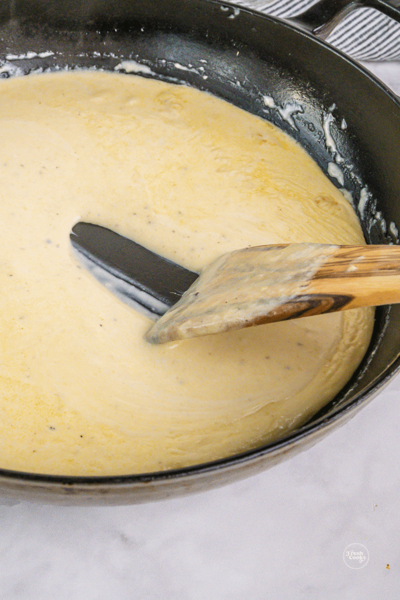 Alfredo sauce is ready with you pull a spoon back and you can see the bottom of pan for a second. 