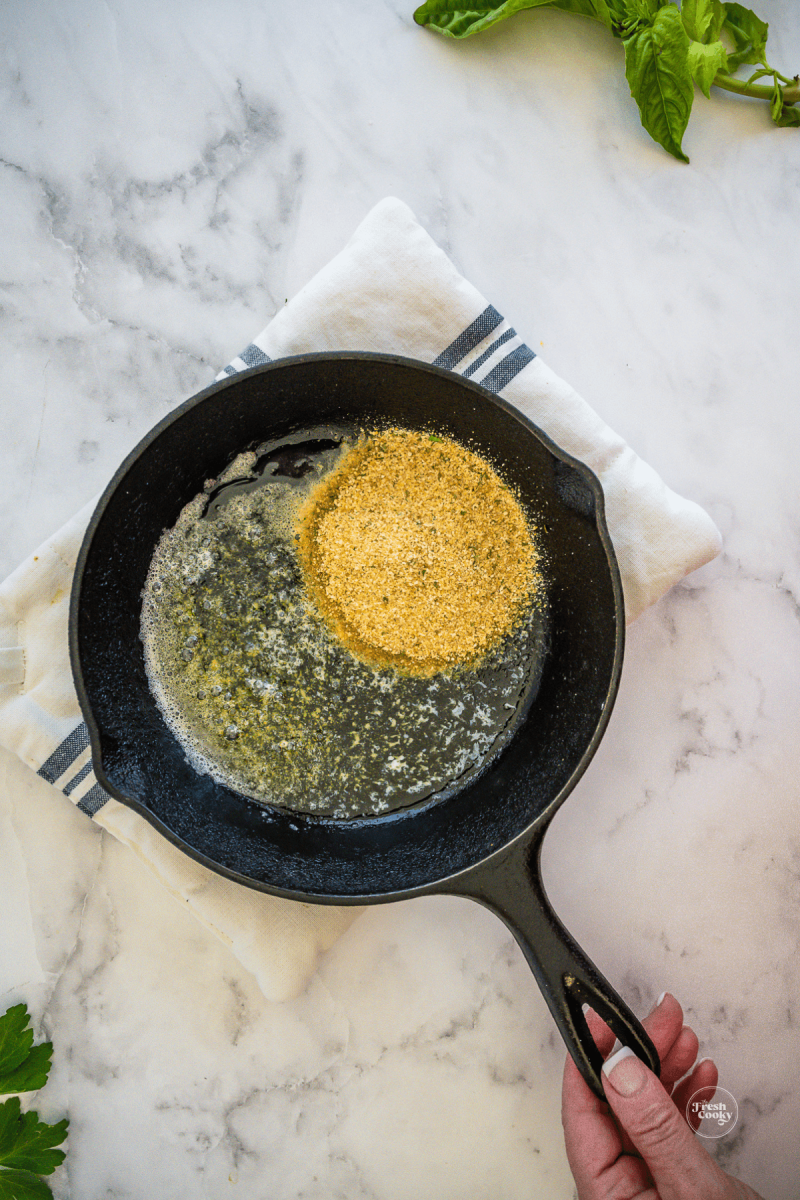 Add bread crumbs to butter in skillet.