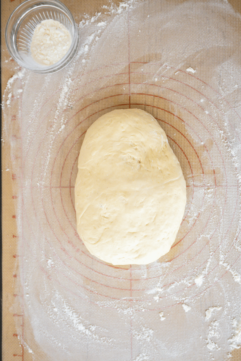 Hand shape dough into rough rectangle for stromboli.