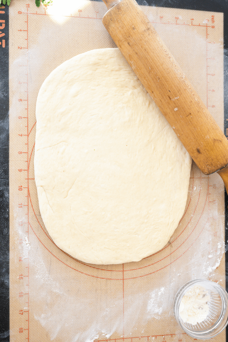 Using hands and rolling pin, roll dough into large rectangle. 
