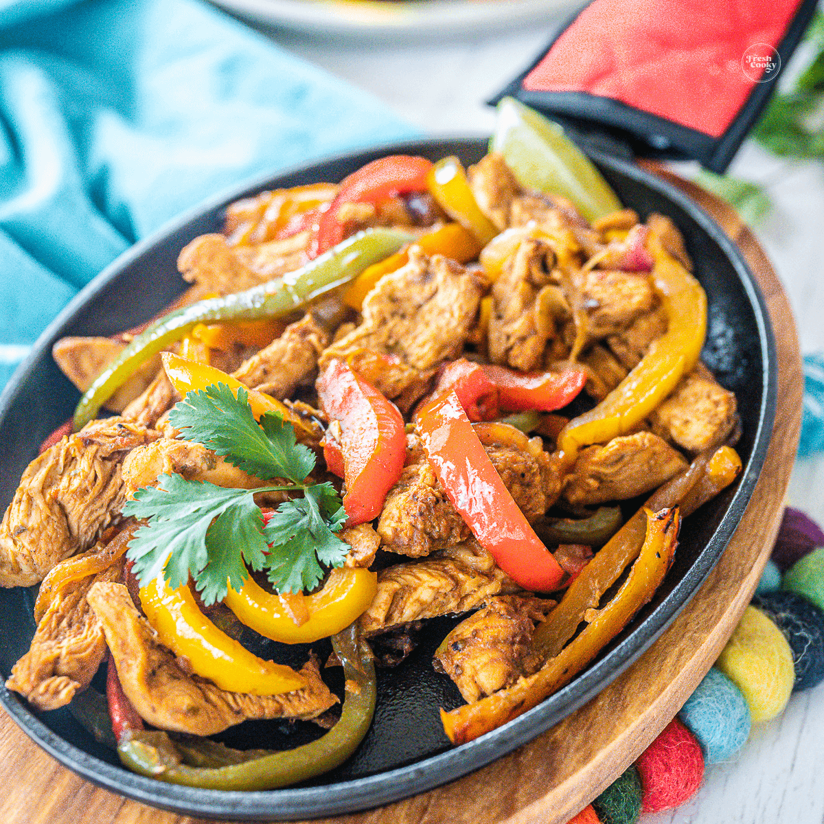 Delicious chicken fajitas in a cast iron pan. 