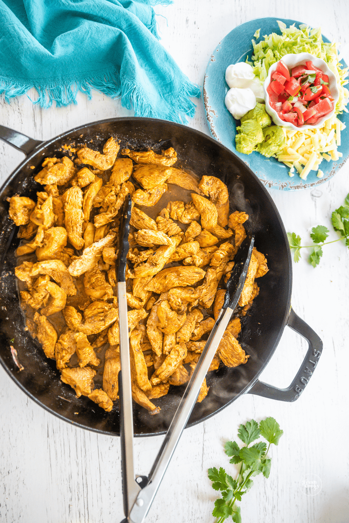 Chicken strips sauteing in skillet for fajitas.