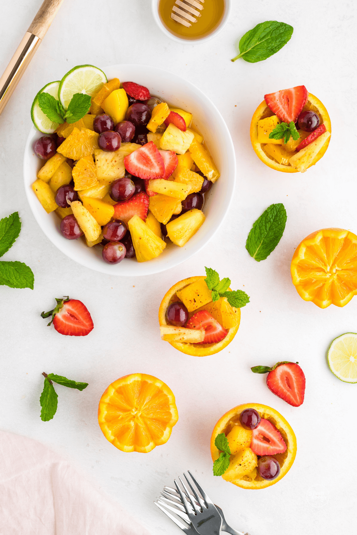 Spoon some of the Mexican fruit salad into fruit cups.