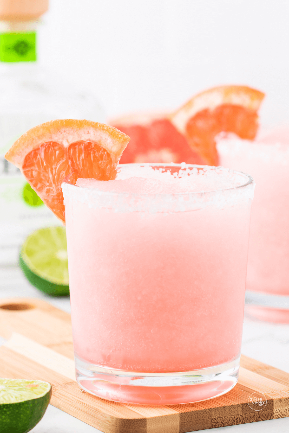Grapefruit Paloma cocktail in glasses with wedge of grapefruit.