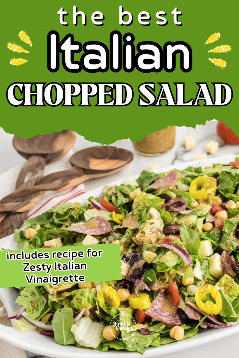 Best Italian chopped salad recipe in a large bowl with tongs and dressing in background, to pin.