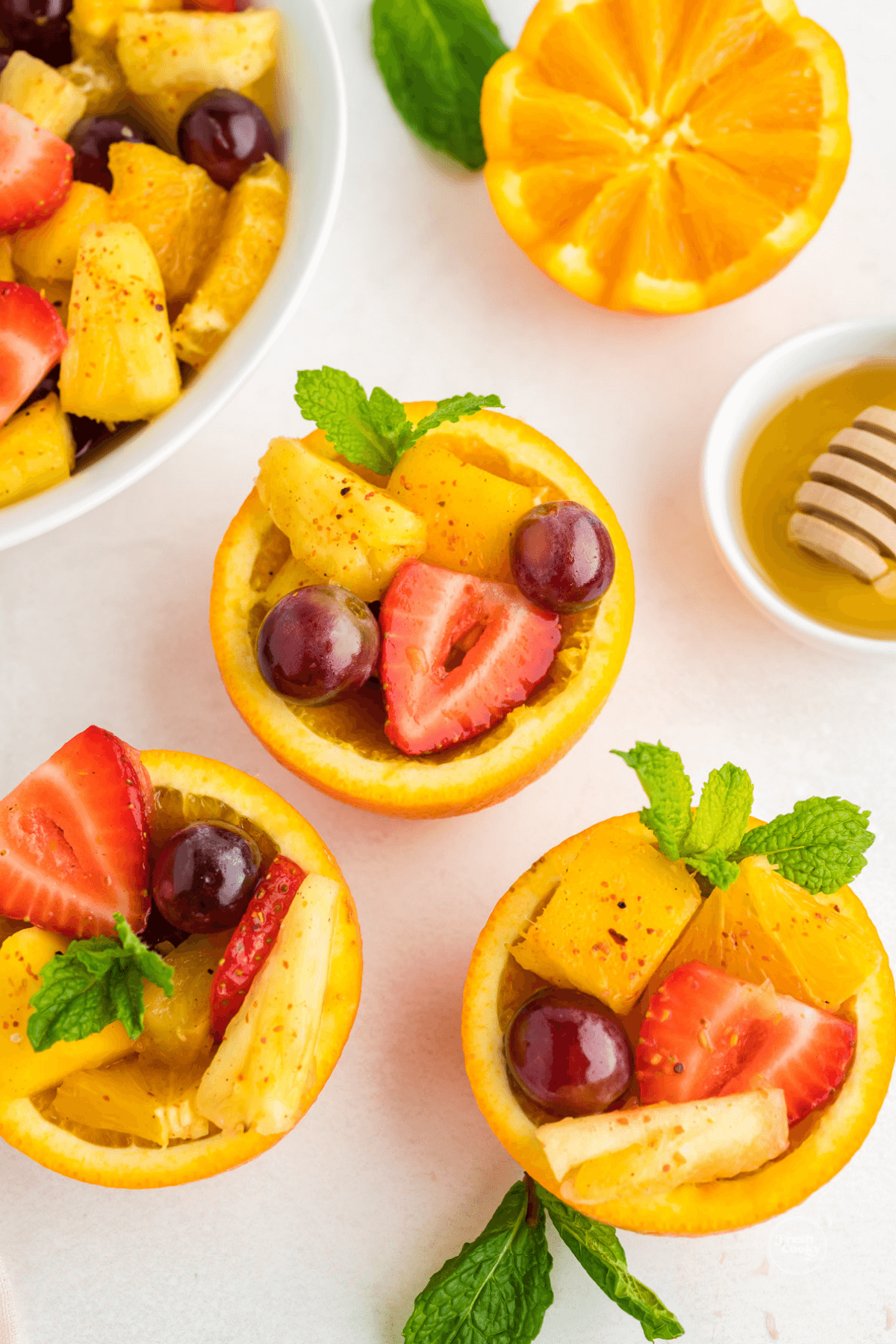 Spoon some fruit salad into orange fruit cups for a fun serving twist!
