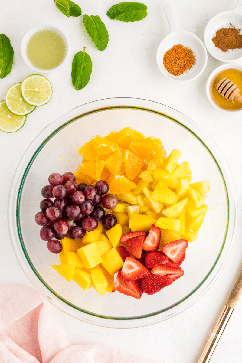 Place cut up fruit into a bowl before tossing with dressing. 