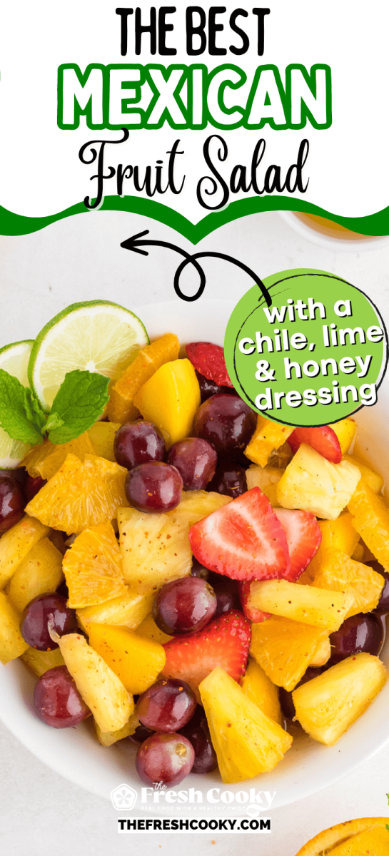 Serving bowl filled with fresh fruit, tossed in a honey-lime Tajin dressing - to pin.