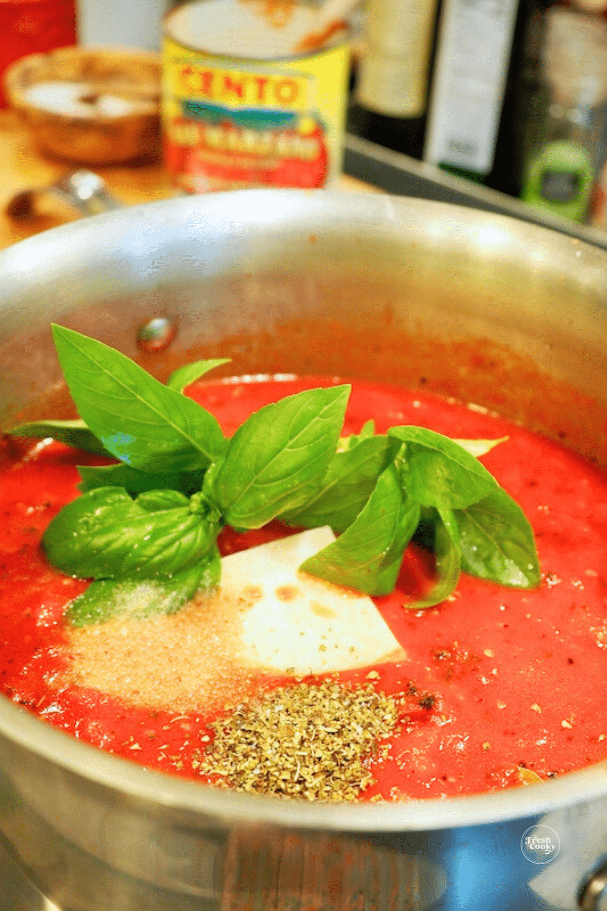 Pasta sauce being cooked in a large pot, low and slow.