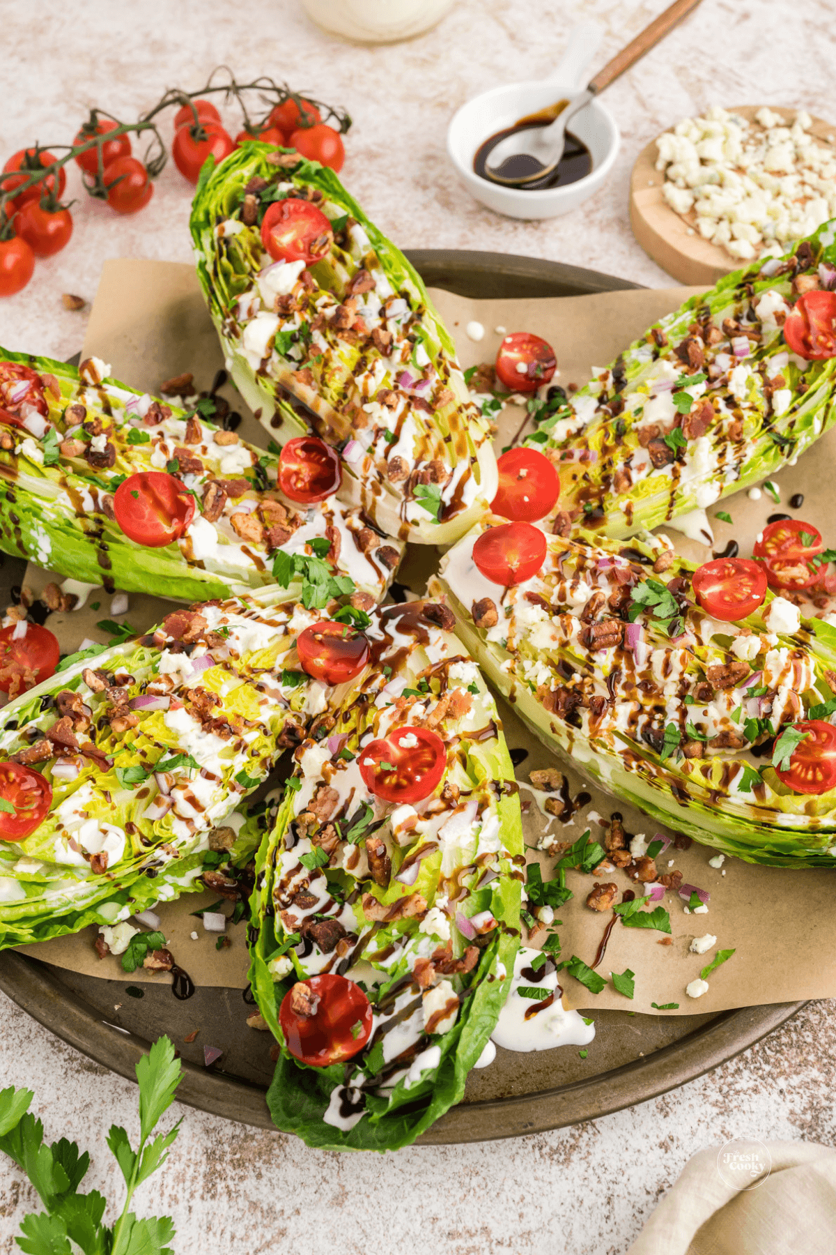 Romaine wedges dressed with blue cheese dressing, blue cheese crumbles, tomatoes, bacon bits, pecans and drizzled with balsamic glaze.