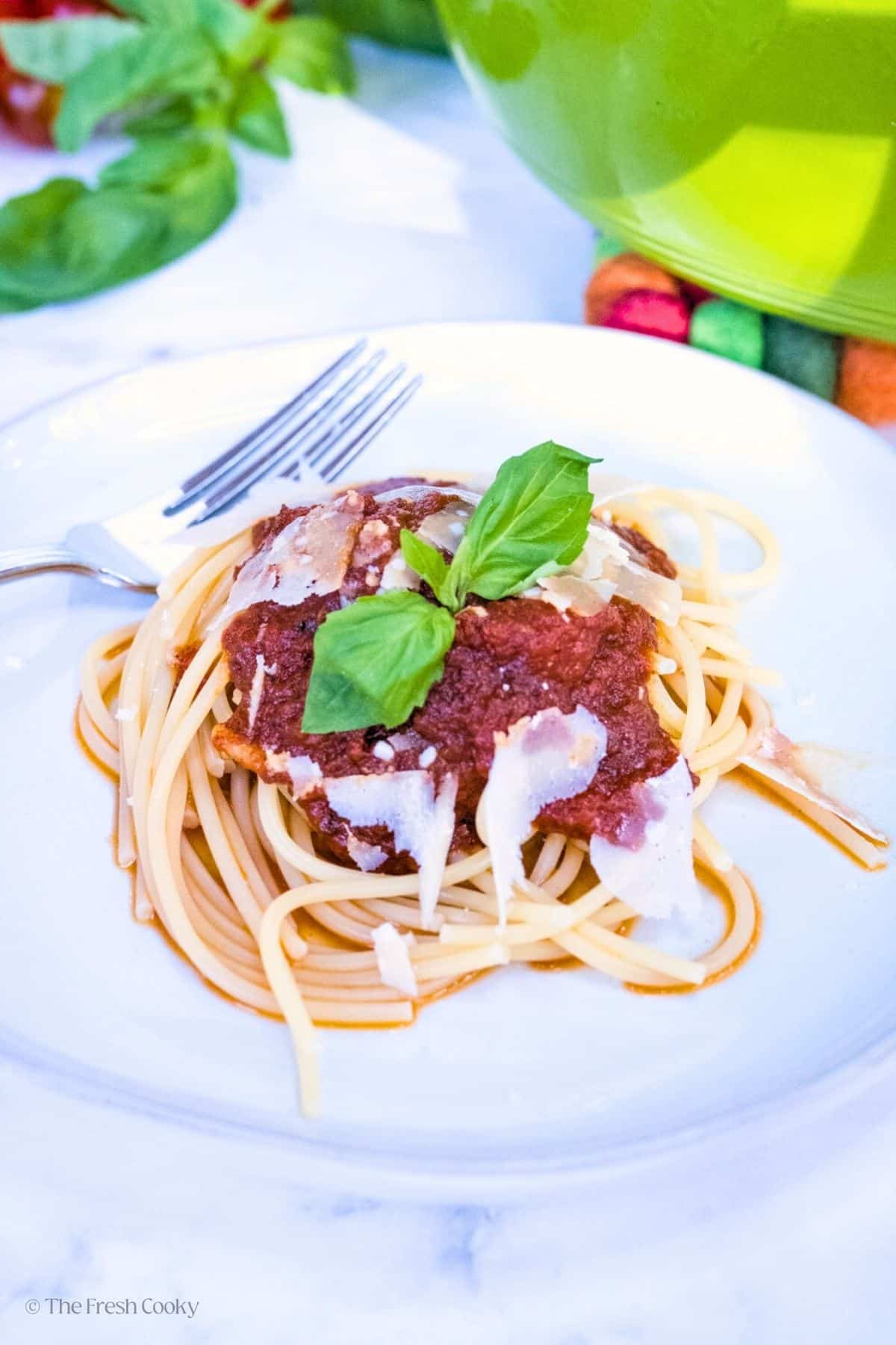 Plate of spaghetti with rich spaghetti sauce on top.