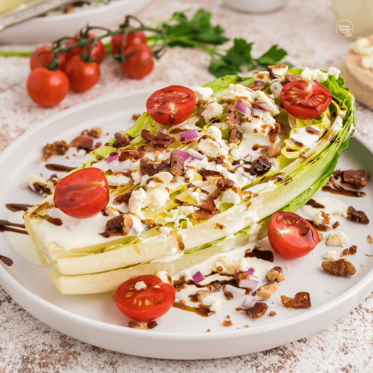 Steakhouse wedge salad with romaine on a plate with all the toppings.