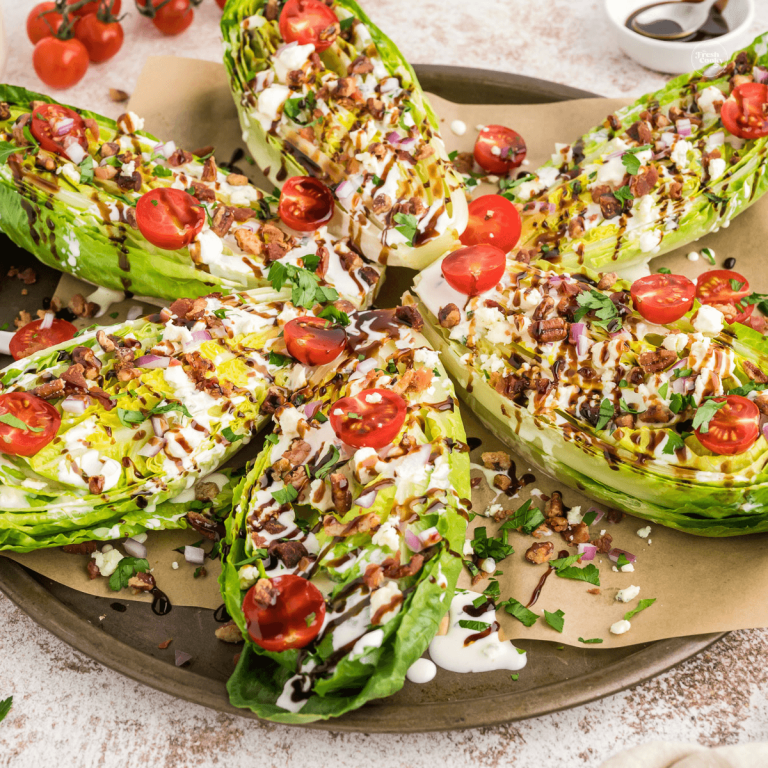 Wedge salads made with romaine hearts on platter with all the toppings.