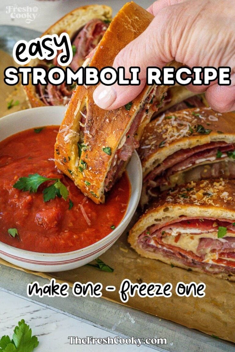 Hand dipping a piece of stromboli into marinara sauce, to pin.