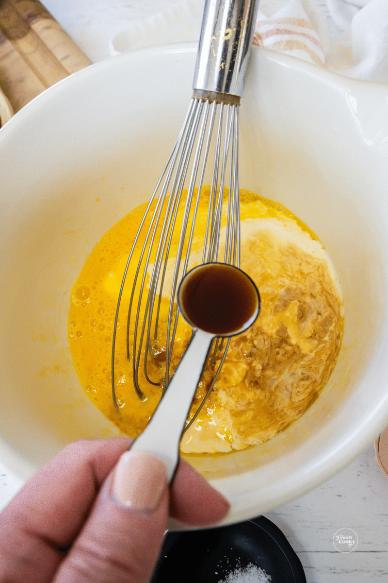 Add vanilla and salt to cinnamon roll casserole custard. 