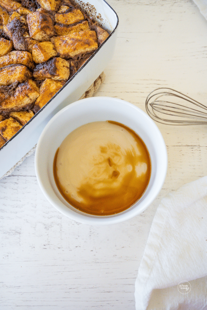 Whisking vanilla into canned frosting for casserole. 