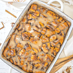 Cinnamon roll casserole pan full of the cinnamon rolls with icing.