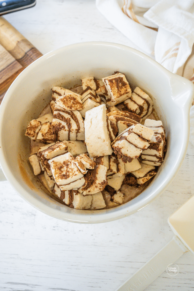 Add chopped cinnamon rolls to custard mixture. 