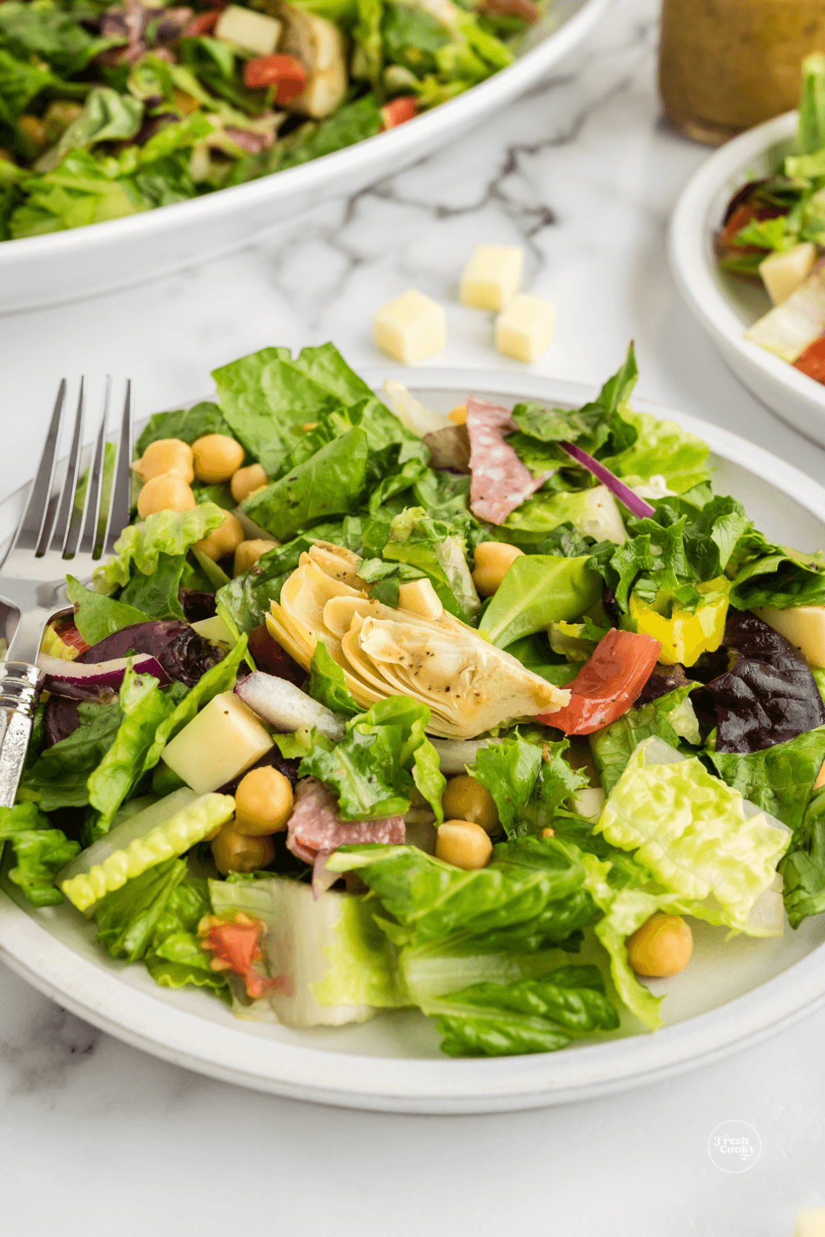 Plated Italian chopped salad recipe with fork dressed for enjoying.