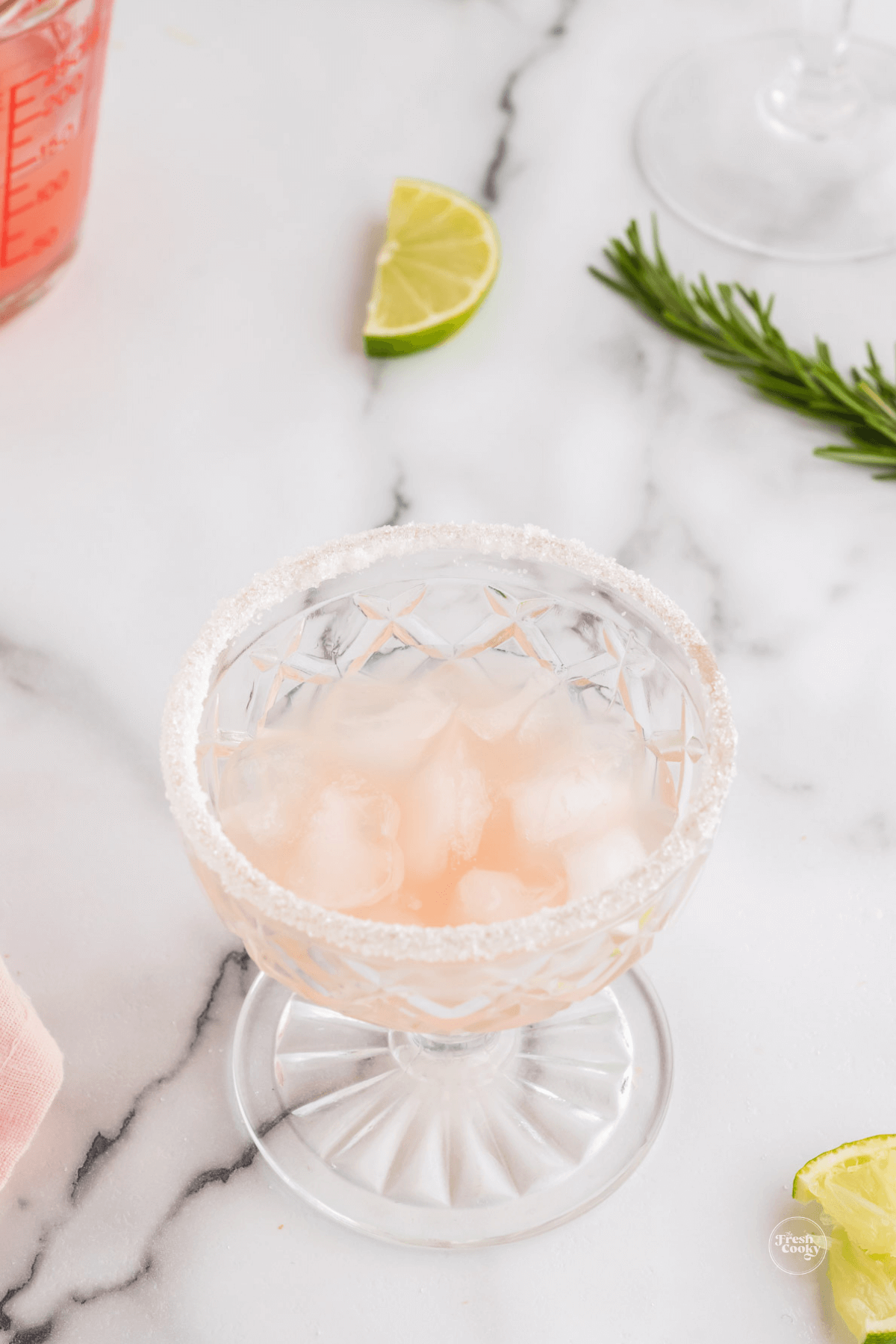Pour grapefruit juice into glass with ice, squeeze the lime.
