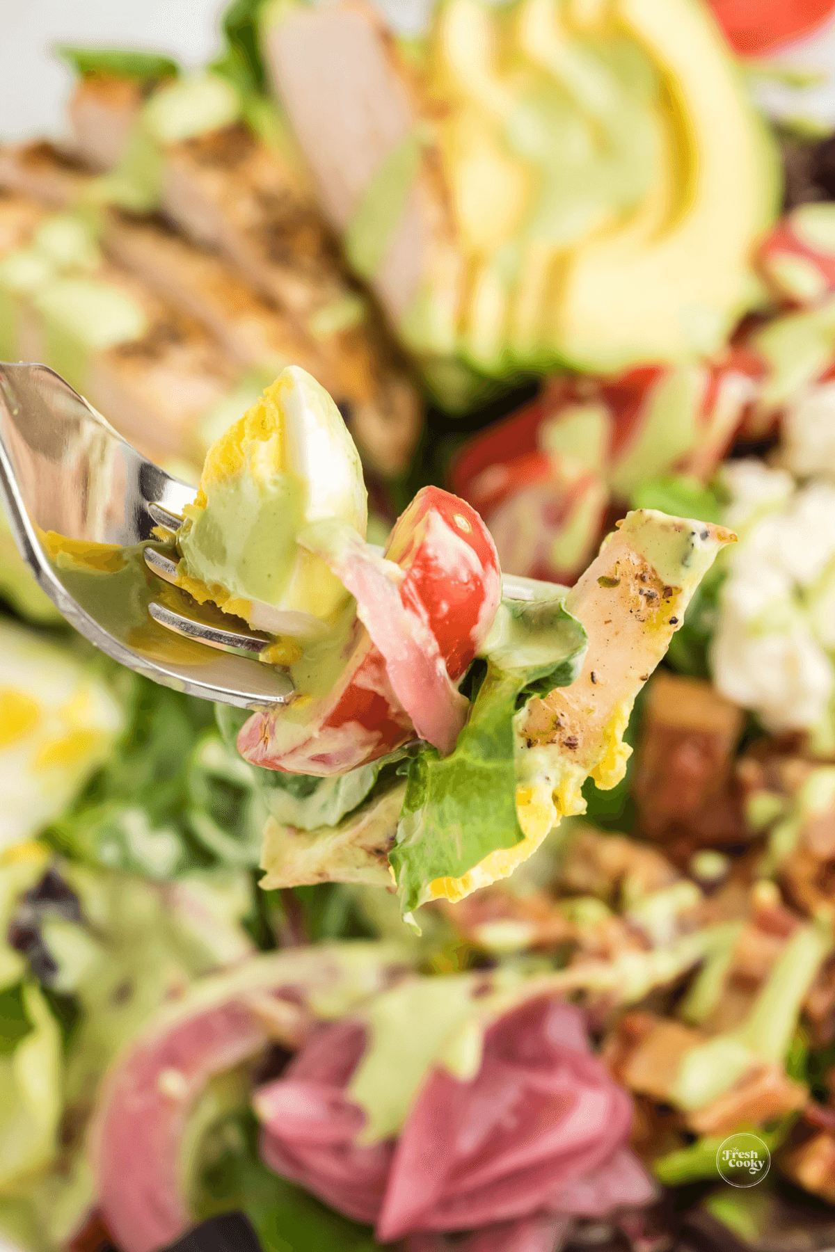 Bite on a fork of green goddess cobb salad.