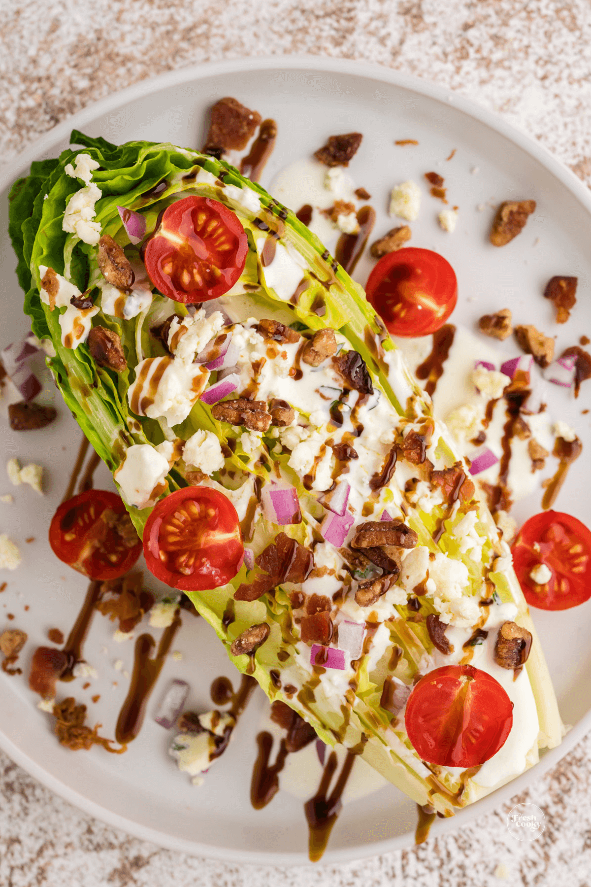  A wedge salad made with romaine lettuce topped with creamy homemade blue cheese dressing and toppings. 