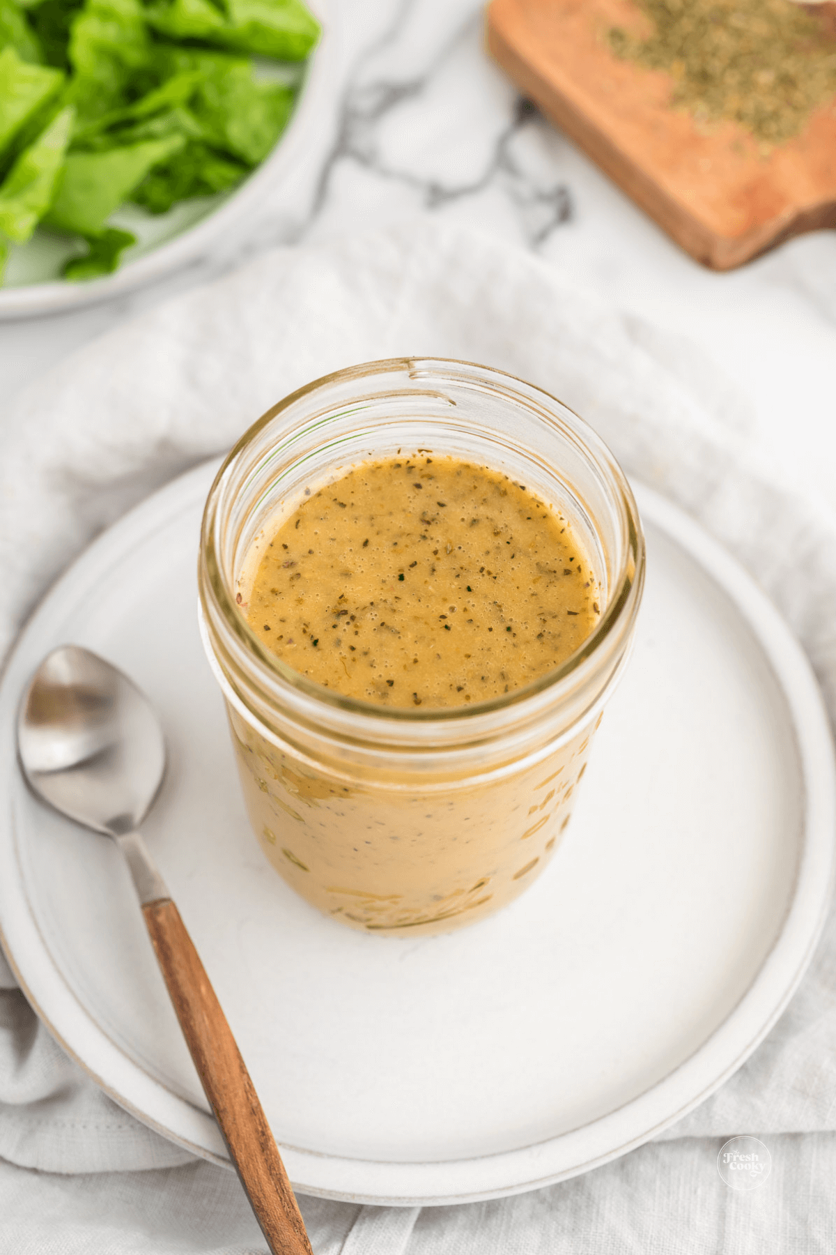 Ingredients in jar for Italian dressing.