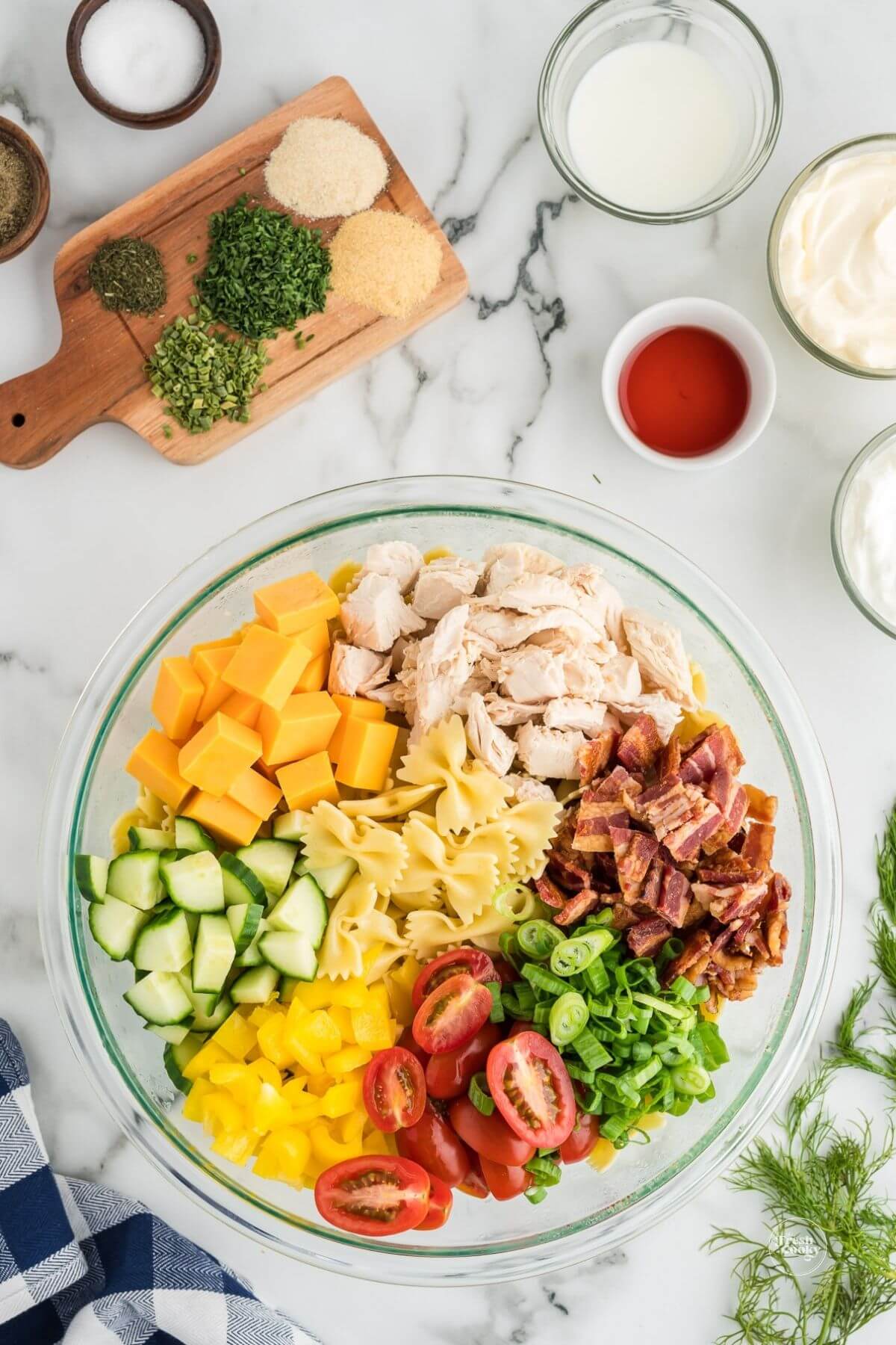 Ingredients for chicken bacon ranch pasta salad in bowl, ready to combine.