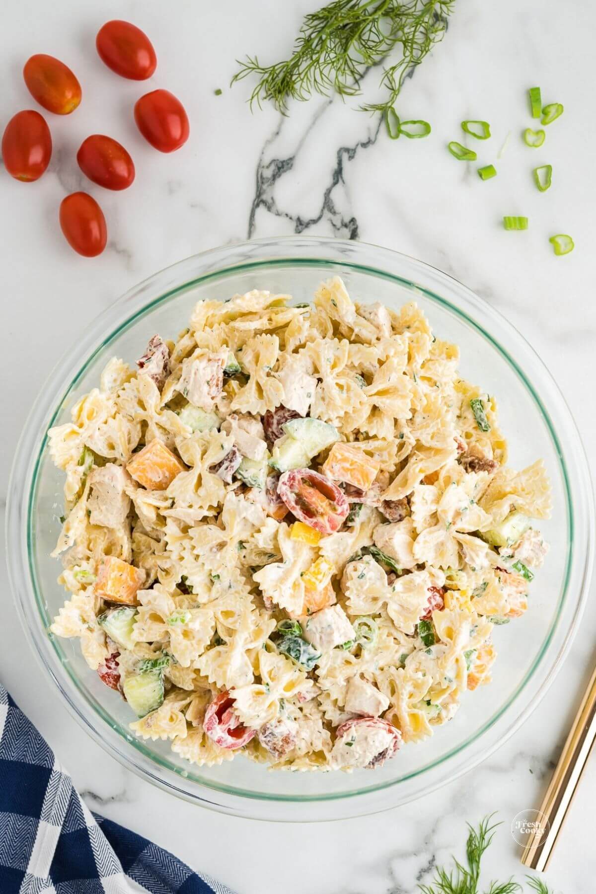 Combining ingredients for pasta salad.