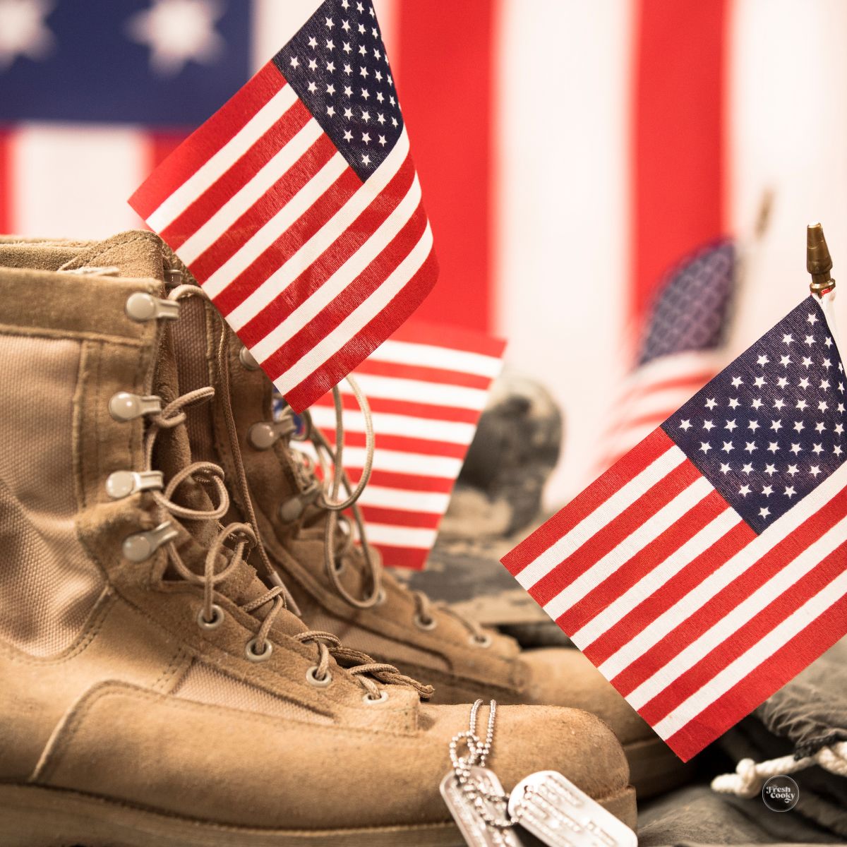American flags in empty soldiers boots with dog tags, celebrating Memorial day.