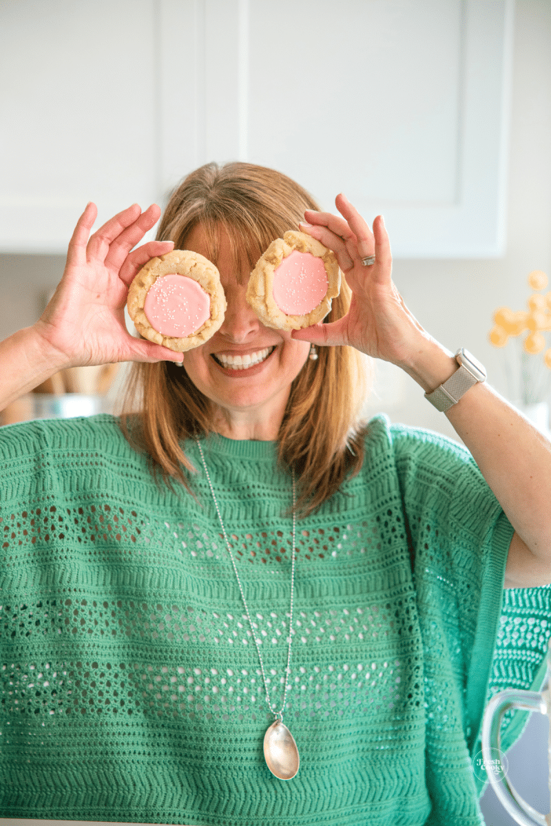 Kathleen holding up cookies for eyes. 