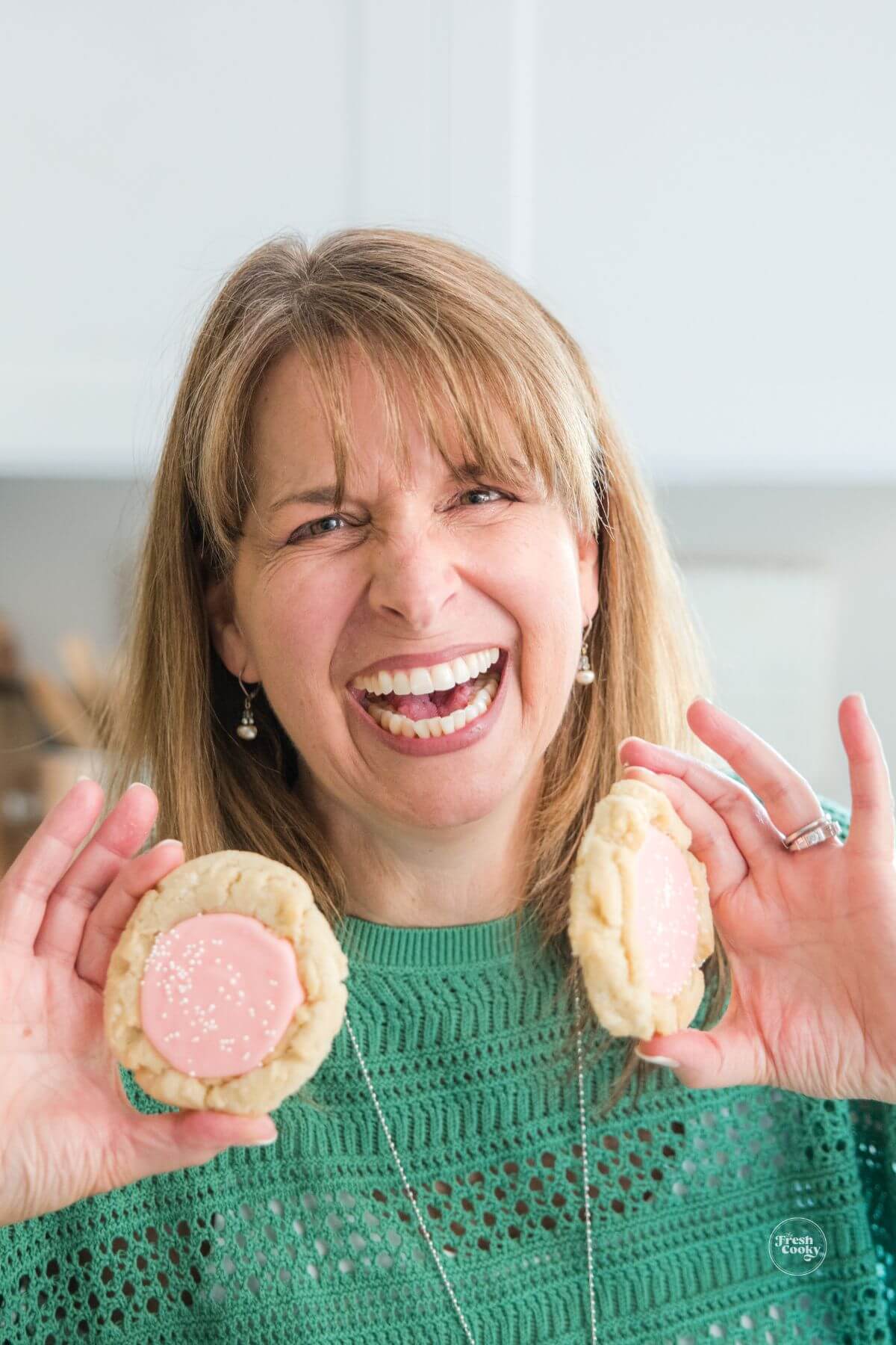 Kathleen laughing with cookies in hand.