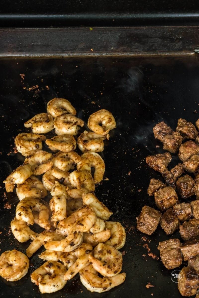 Add shrimp next to the steak tossing to combine. 