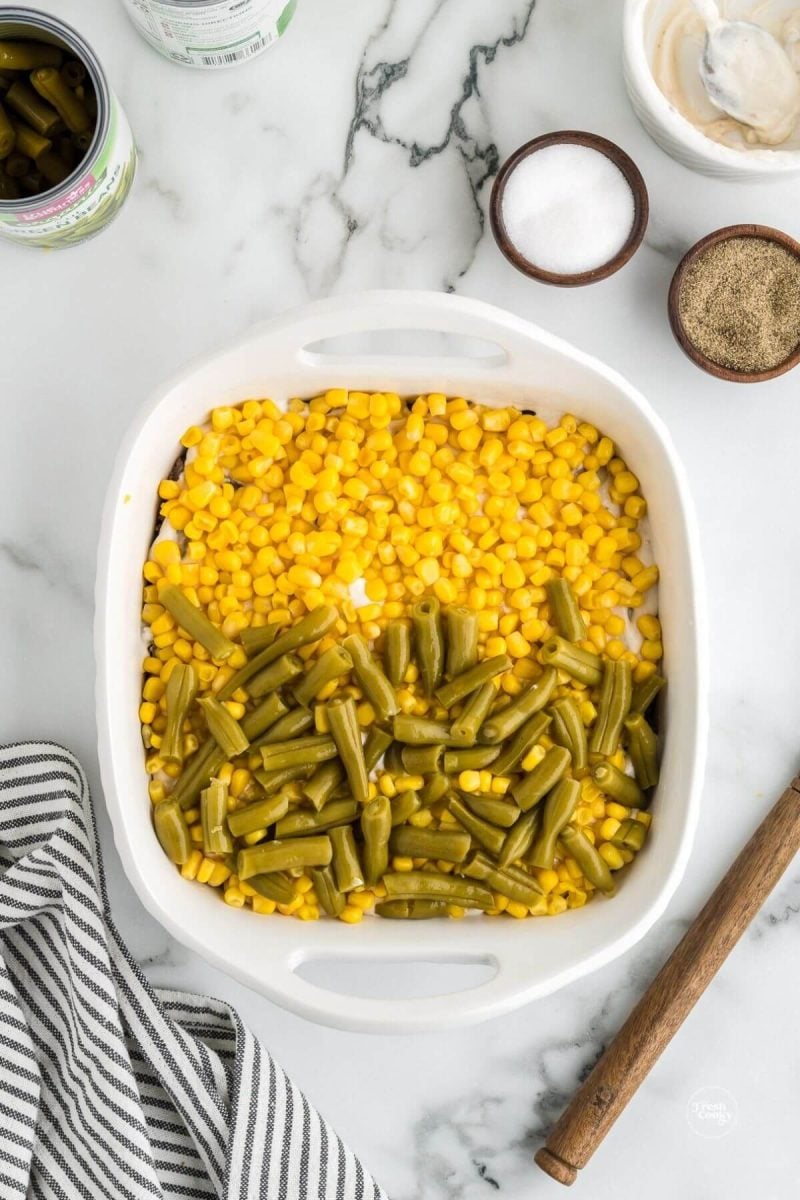 Layer corn and green beans for tater tot casserole. 