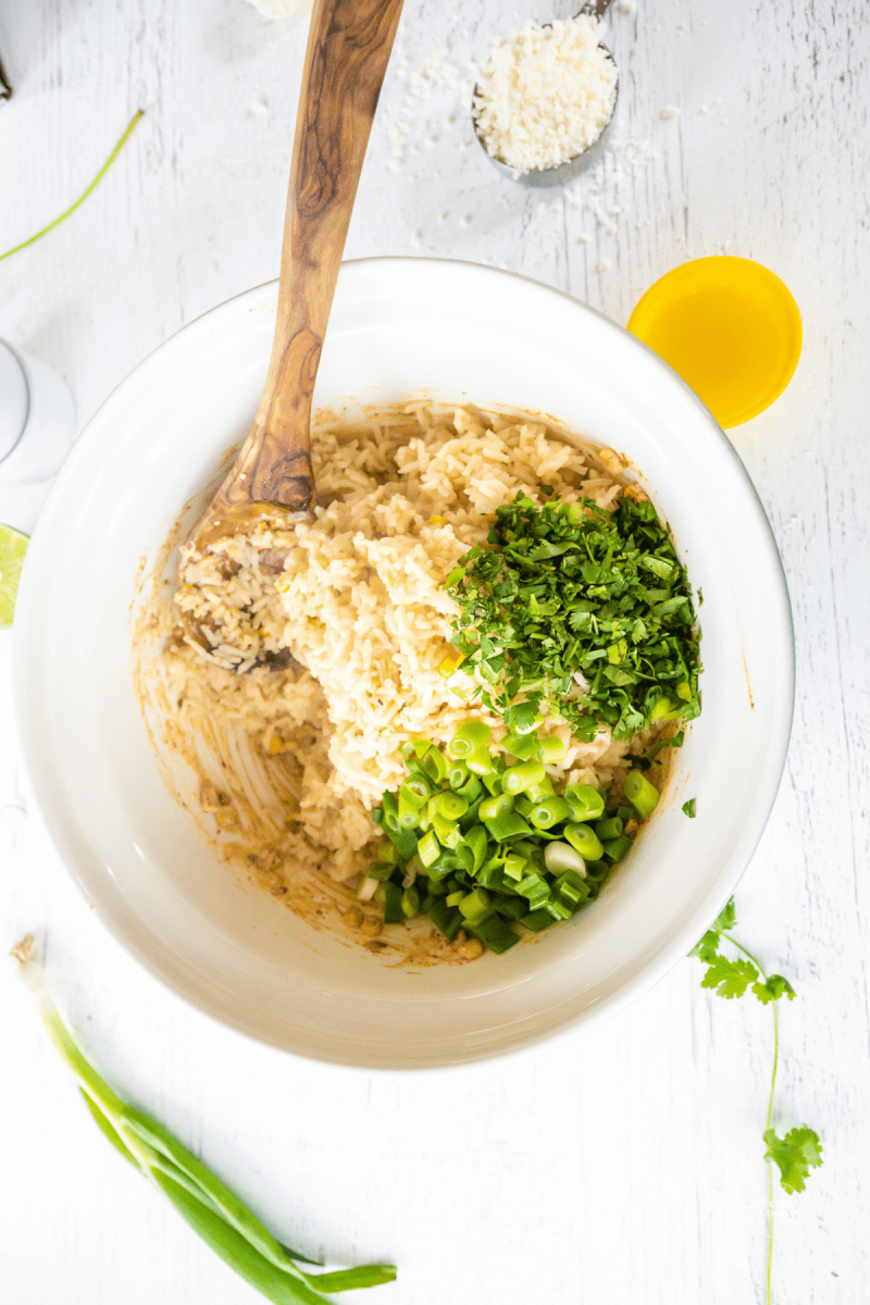 Add seasonings, cilantro and green onions to Mexican corn rice recipe. 