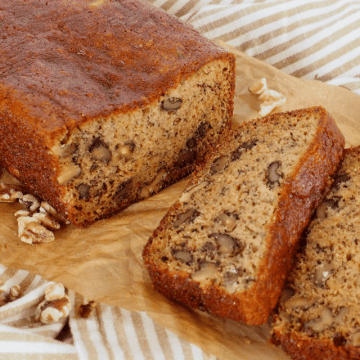 Gluten free banana bread recipes, sliced on parchment for serving.