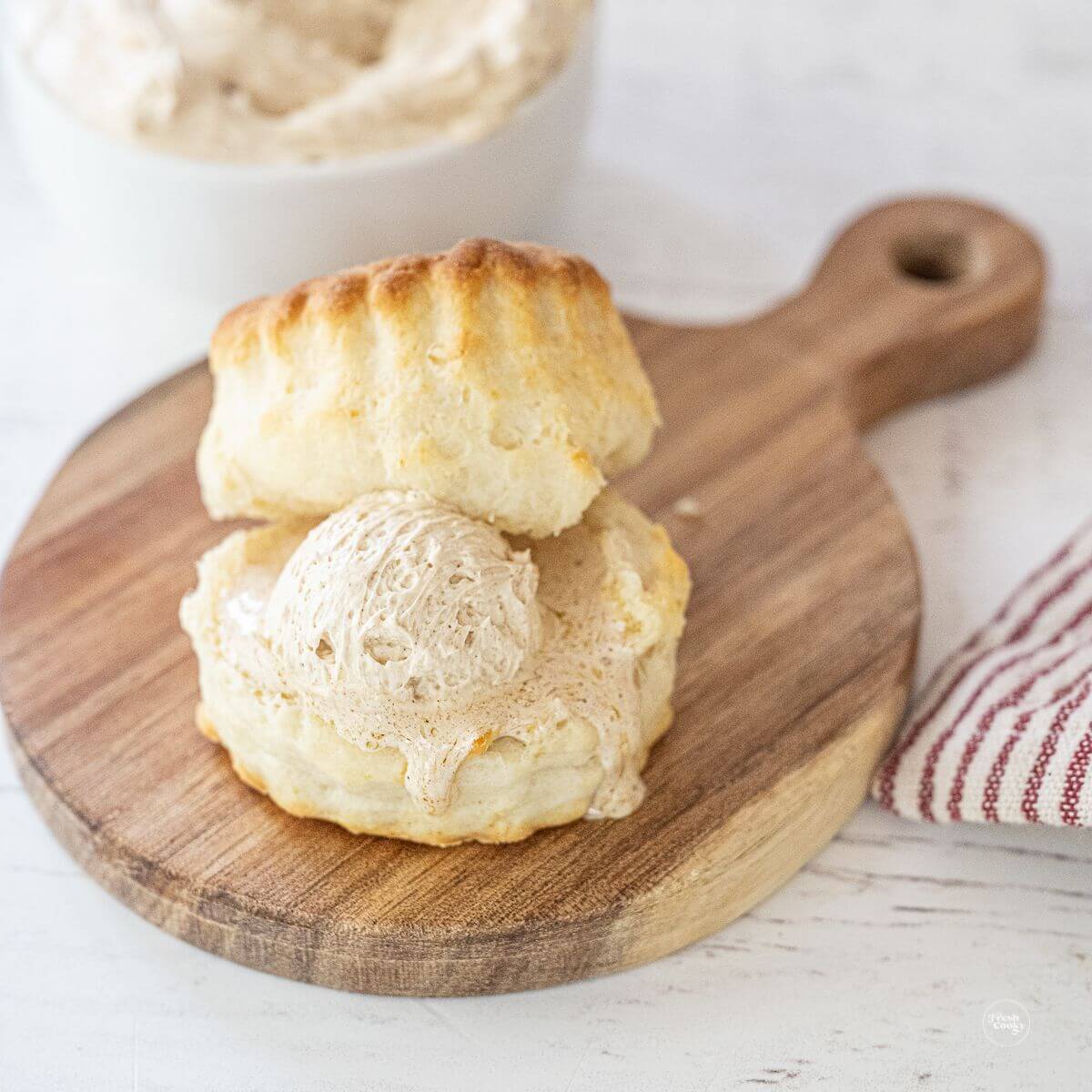 Easy 2 ingredient homemade biscuit with honey butter on cutting board.