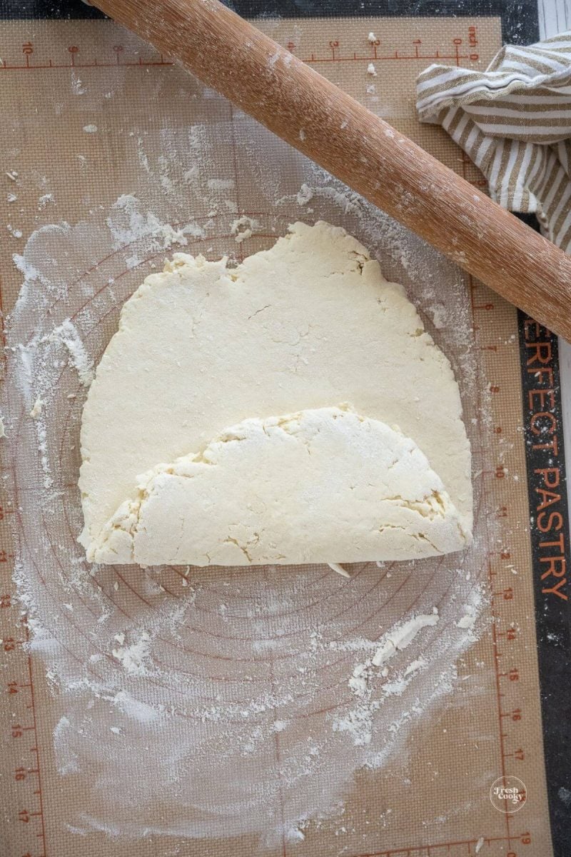 Folding dough one half towards the middle.