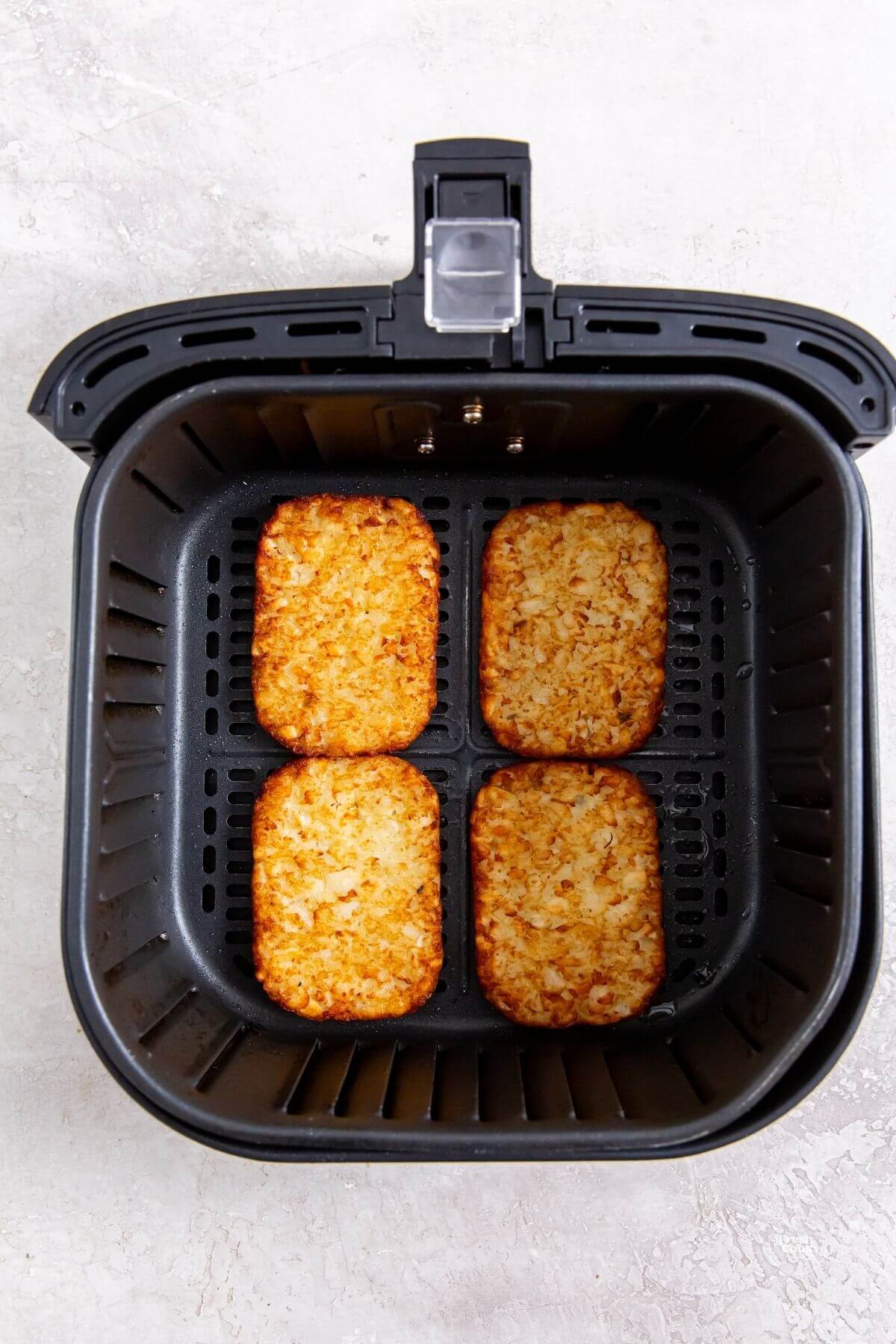 Place hash browns in air fryer, don't crowd them.