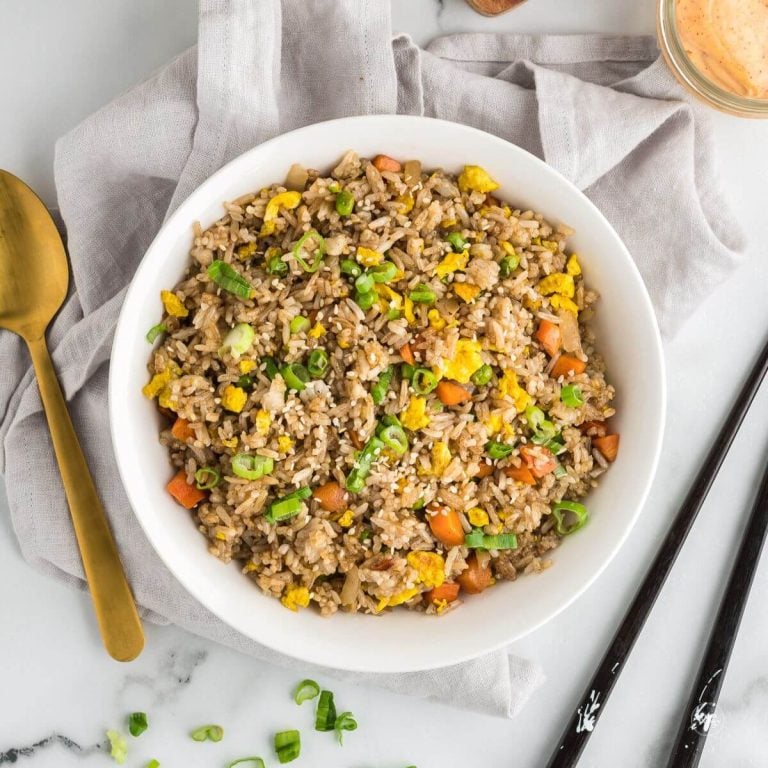 Benihana copycat Hibachi fried rice recipe in large bowl with spoon and chopsticks nearby.
