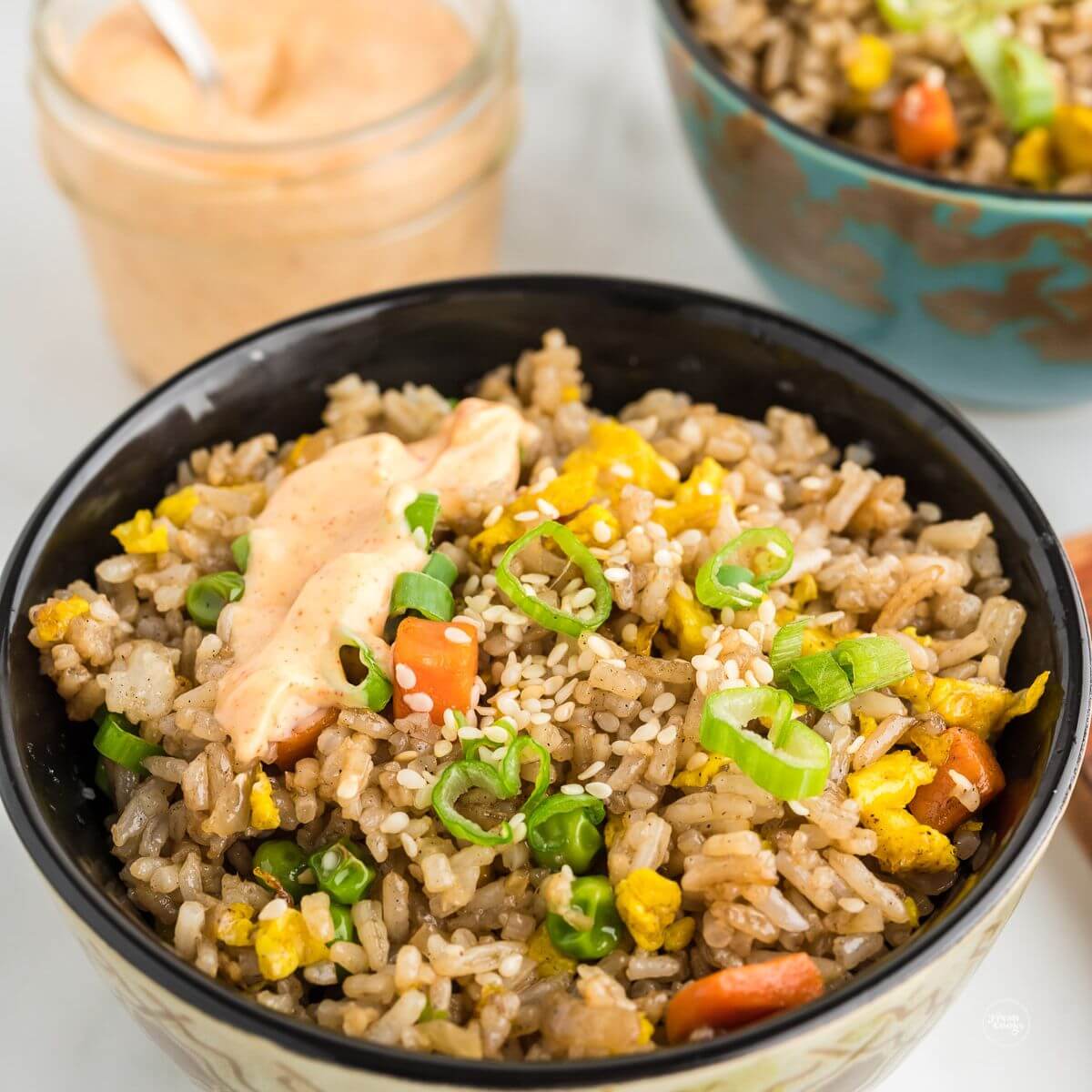 Hibachi fried rice recipe Benihana style in bowl drizzled with yum yum sauce.