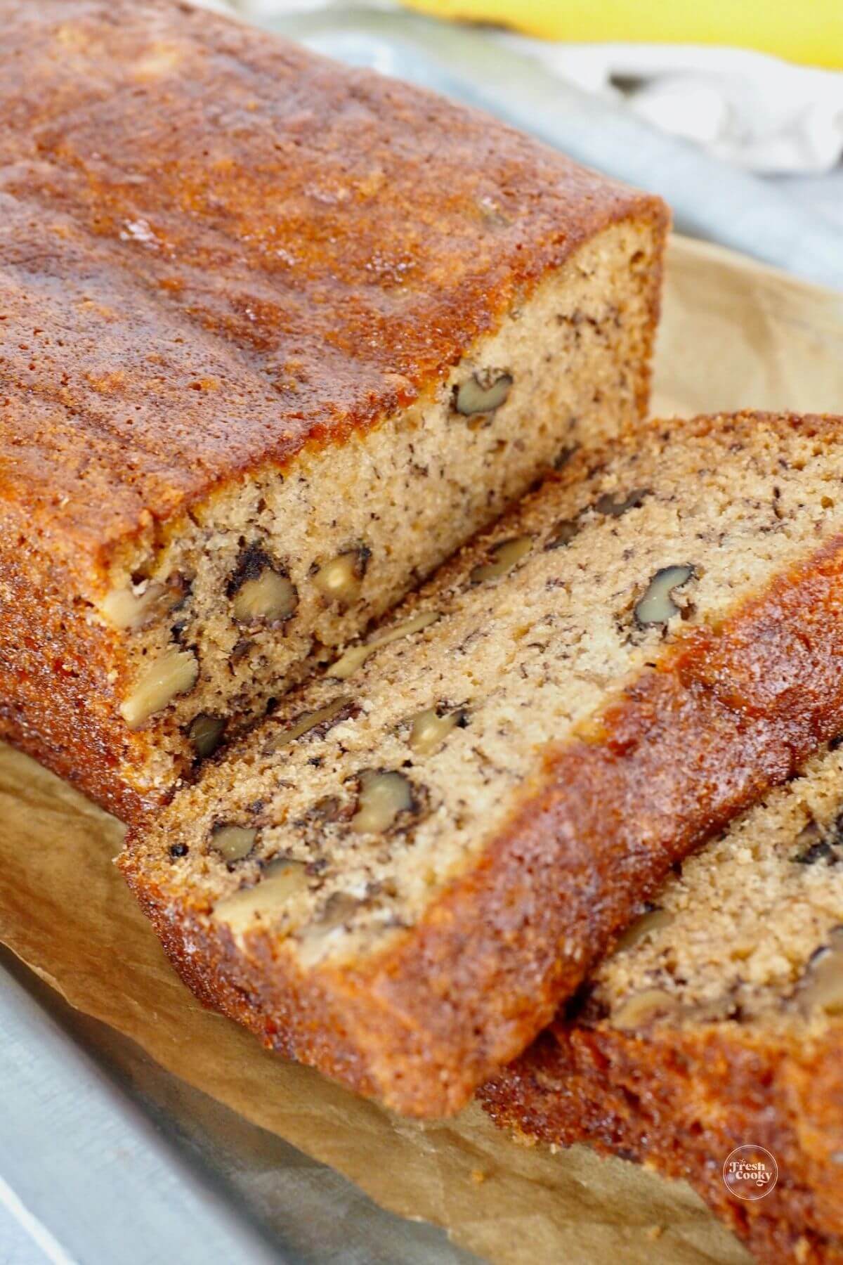 Best ever high altitude banana bread recipe sliced with walnuts in bread.