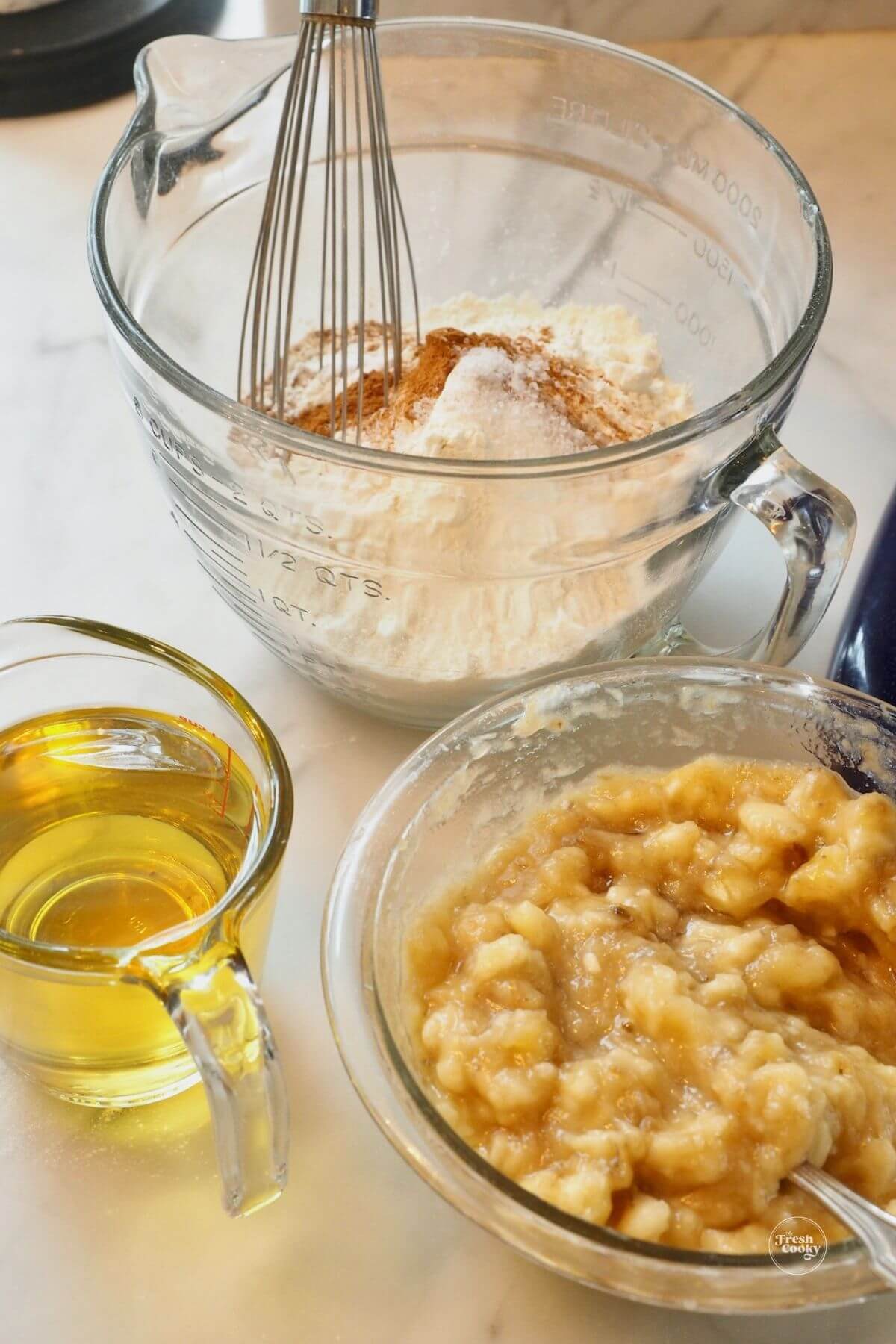 Mashed bananas, oil measured and dry ingredients ready for high altitude banana bread recipes.