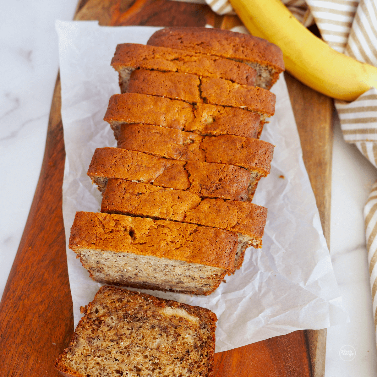 Best ever high altitude banana bread recipe, sliced on a cutting board.