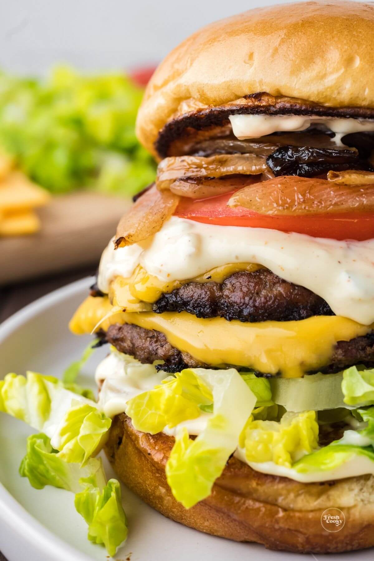 Smash burger with grilled onions and cheese and smash sauce made on blackstone griddle.