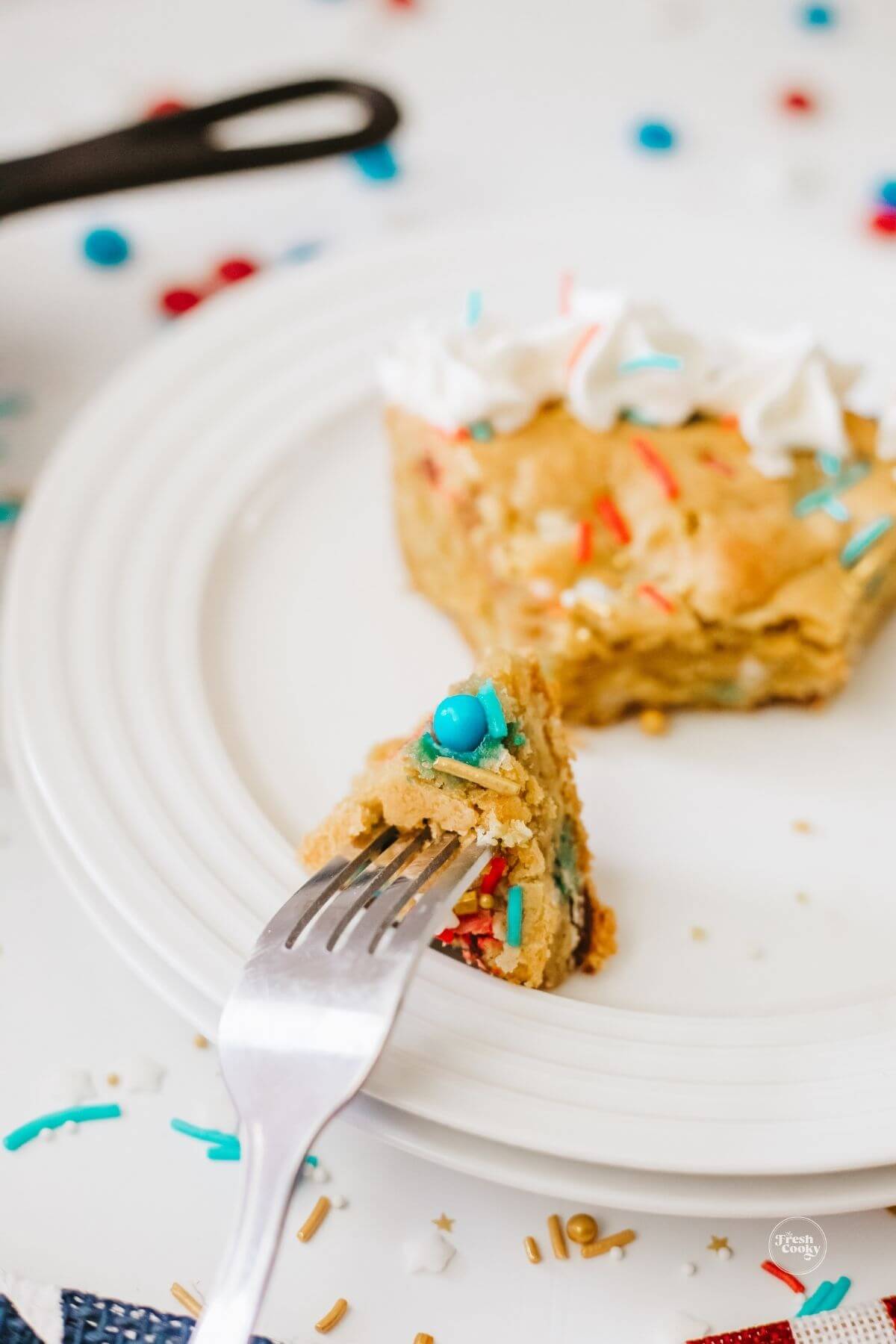 Fork in bite of 4th of July cookie cake.