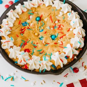 Patriotic 4th of July Cookie Cake in a skillet with frosting.